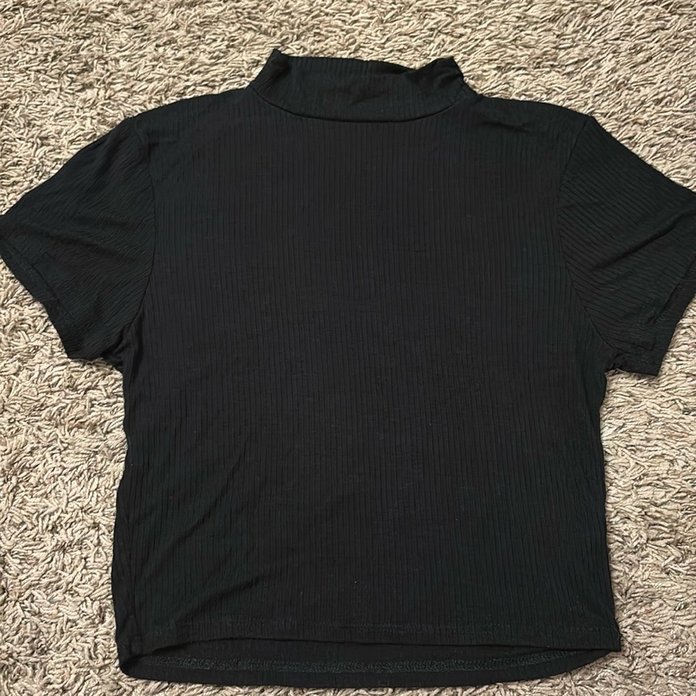 Right, black, crop-top with cut out in the back.